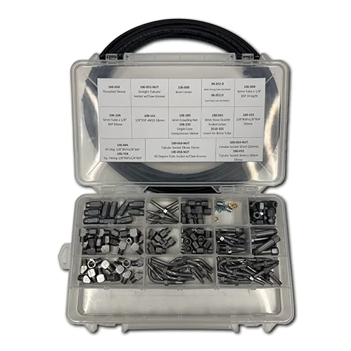 BSP automatic lubrication parts kit with fittings, adapters, hose studs, tubing components, and repair parts organized for heavy equipment lubrication system maintenance.