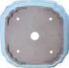 Close-up of blue gradient lip and glossy light green glaze on square stoneware pot