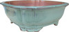 Side profile of high-fired square pot showing glossy dark green glaze and strong form