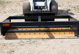 The box grader attached to a skid steer loader.