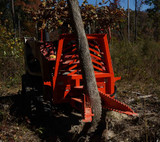 Action shot of the Eterra Skid Steer Riptide Tree and Stump Puller