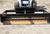 The box grader attached to a skid steer loader.