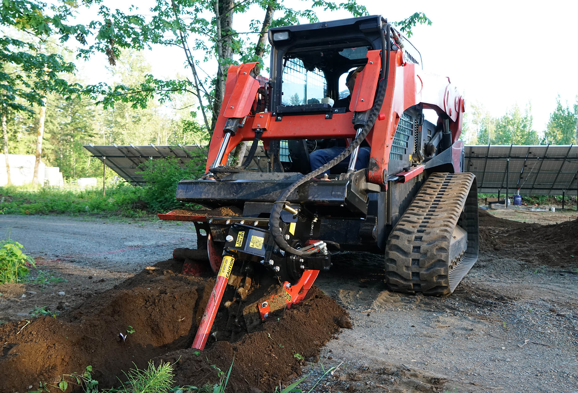 Constructing a water pipeline with the skid steer trencher attachment.