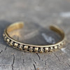 Gold-Tone 28 Skulls Skull Bangle Bracelet