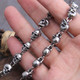 45 Skulls Link necklace holding in a hand