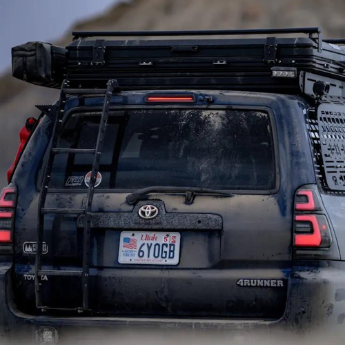 Side shooter LED pod lights installed on a Toyota 4Runner, illuminating the campsite