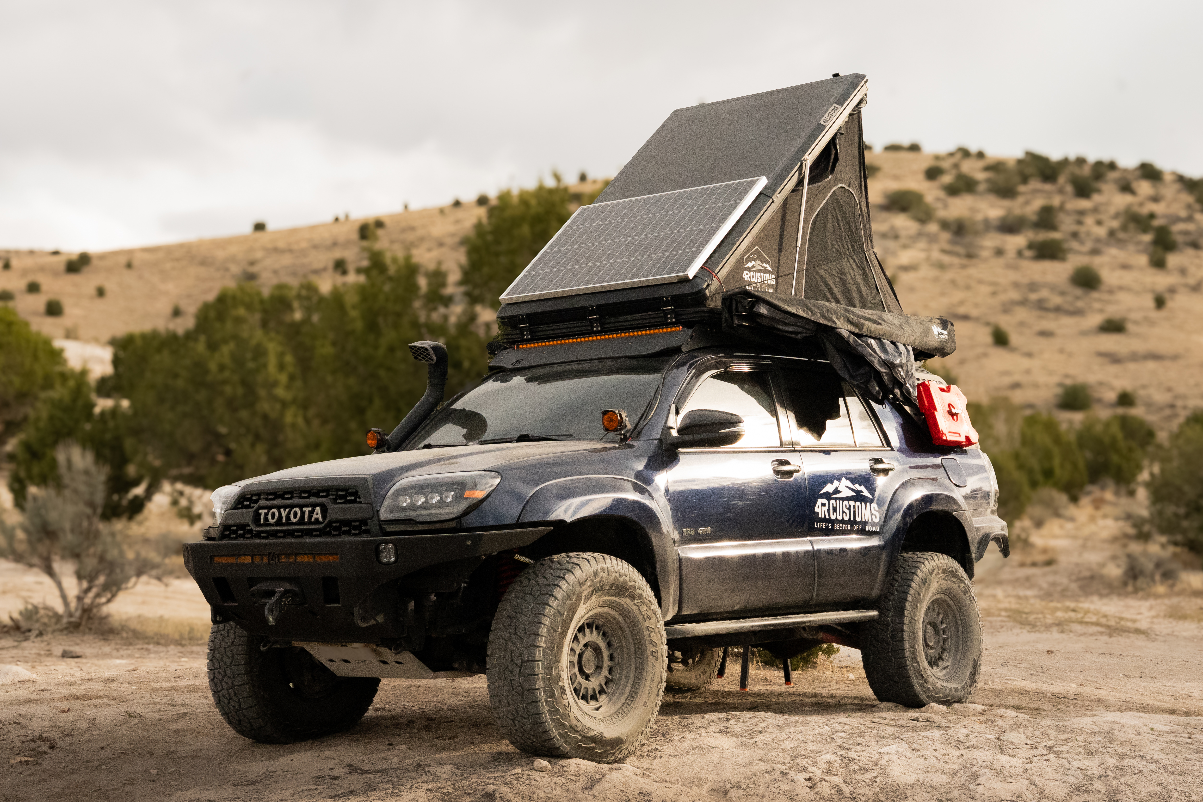 Overlanding Toyota 4Runner parked at camp with rooftop tent and gear in Utah