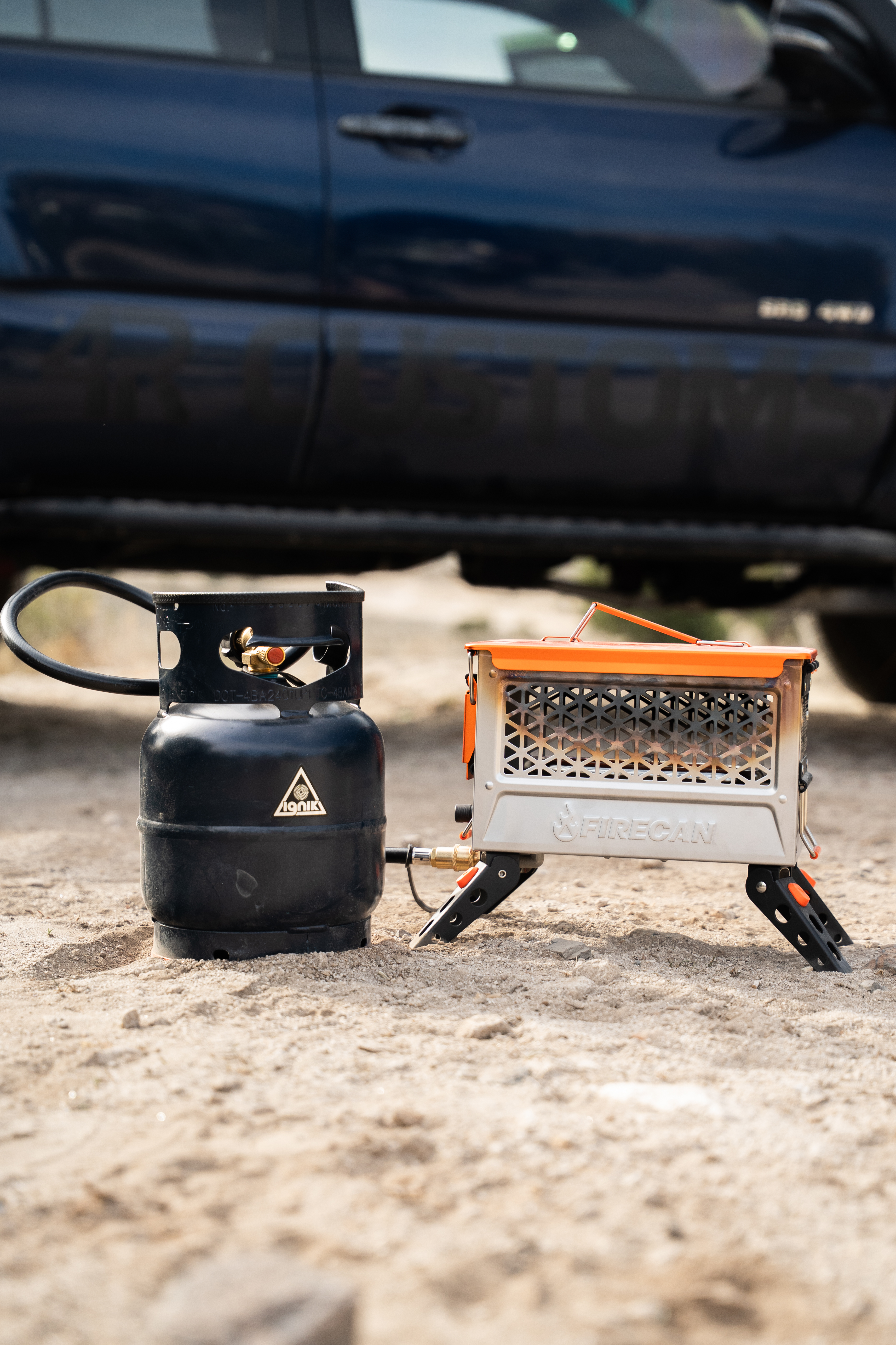 Propane fire can set up next to a Toyota 4Runner overlanding camp