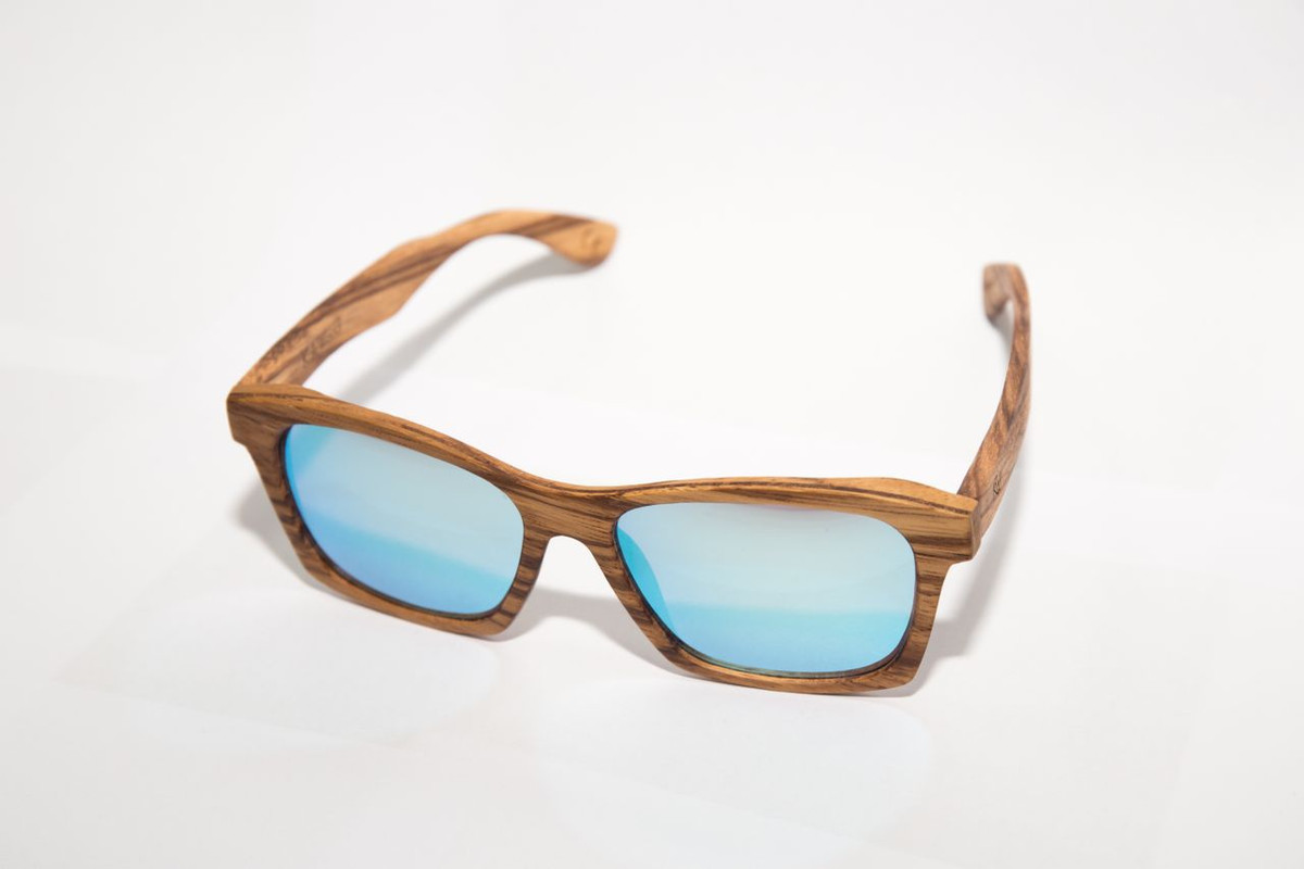 Zebrawood wayfarer sunglasses with ice-blue mirrored lenses on a white background