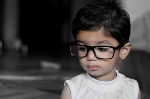 Toddler wearing black rectangular eyeglasses