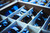 Divided storage tray filled with assorted sunglasses