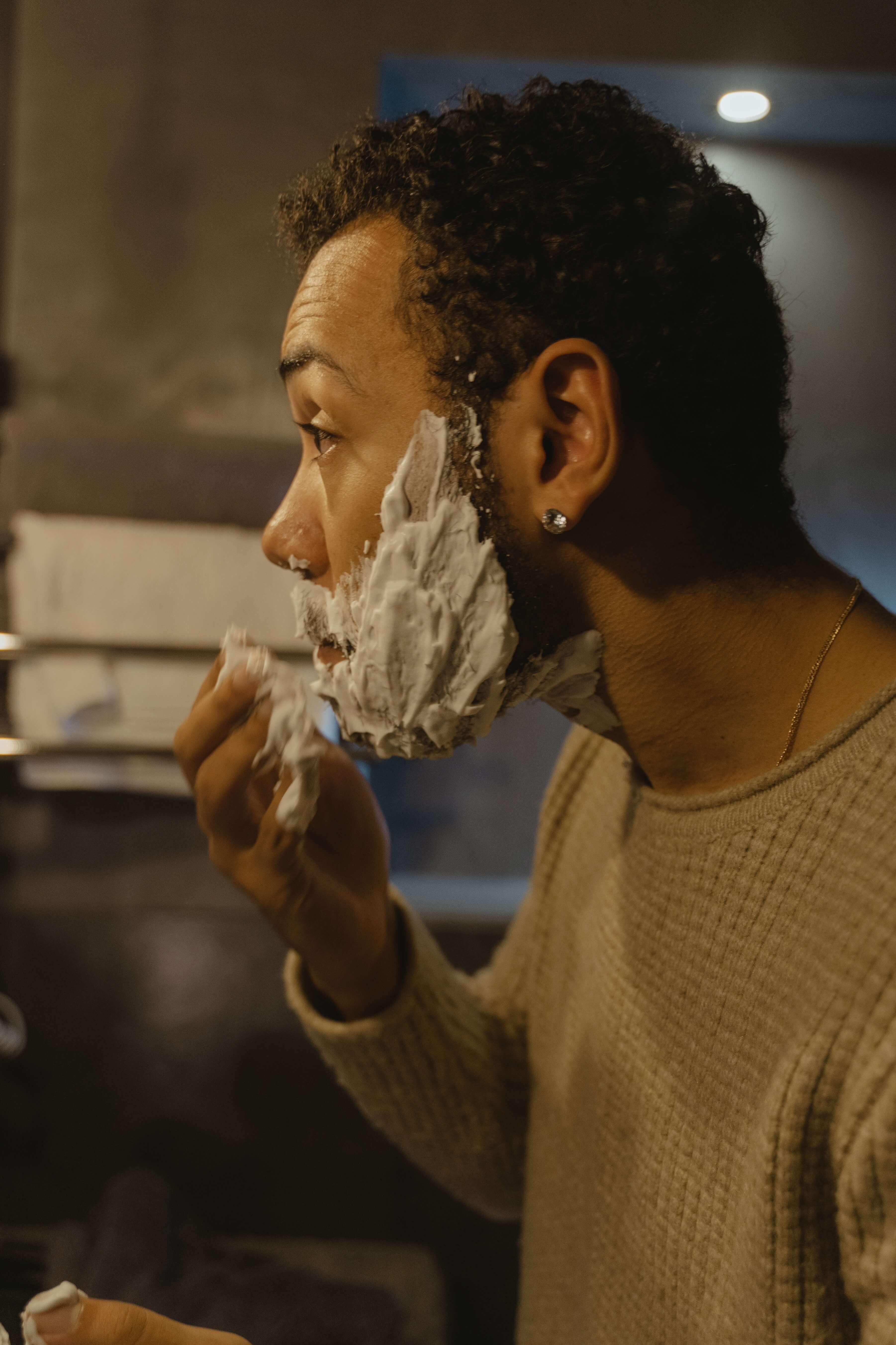 Man putting shaving cream on his face