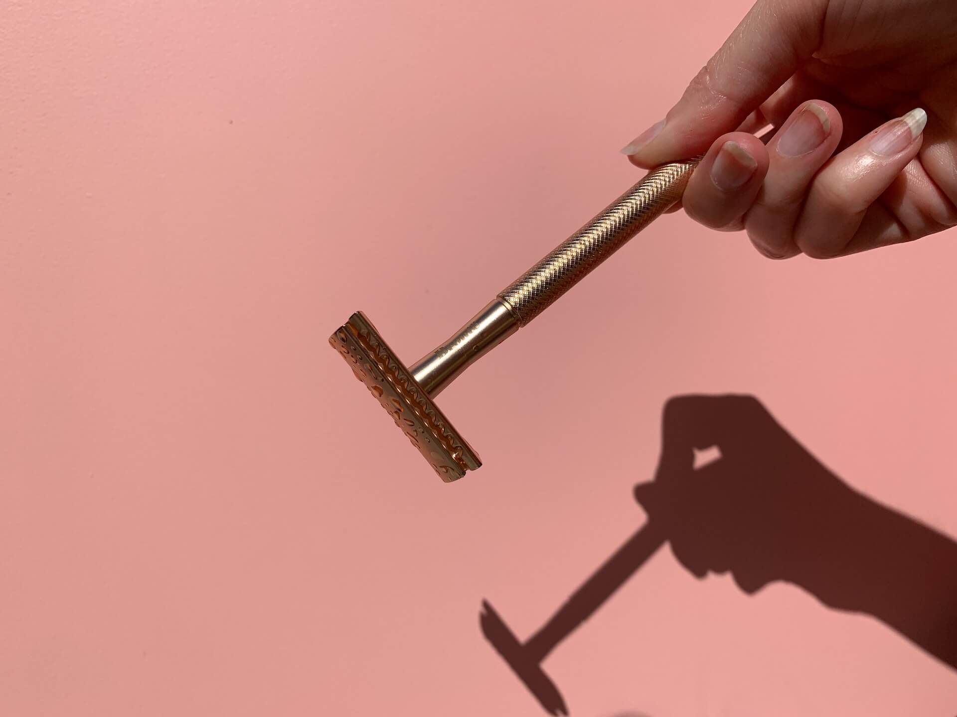 A person holding a gold razor