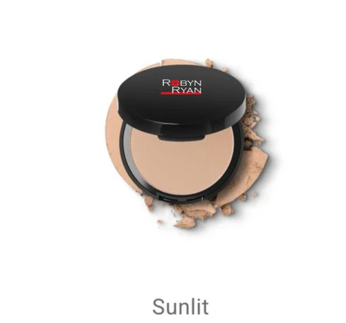 Robyn Ryan Mineral Powder Foundation in shade Sunlit — pressed powder compact with a neutral medium tone and soft, smooth finish, displayed on a background of loose powder for a natural, luxury look.