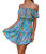 Model wearing the Robyn Ryan™ Coastal Bloom Tropical Garden Midi Dress featuring a sky-blue base with vibrant tropical floral print in orange, mustard, pink, ivory, and deep teal accents. The midi-length silhouette flows naturally with a flattering tie-waist detail, styled for a resort and coastal vacation look.