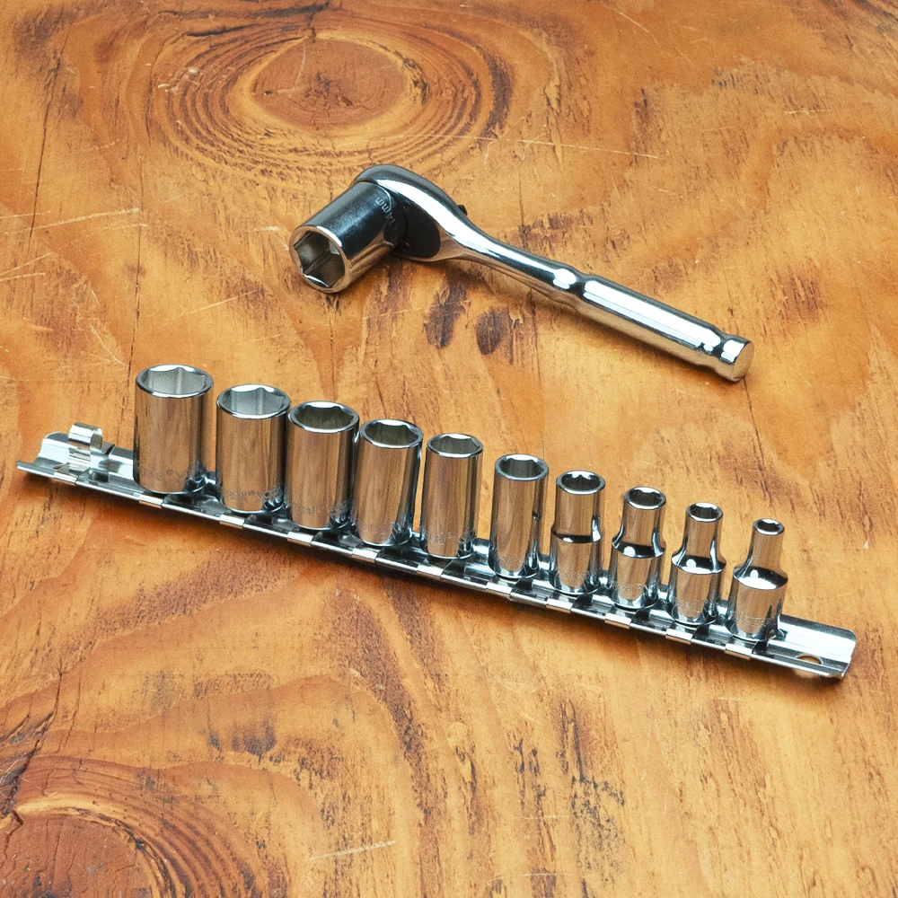 Proferred 1/4" Drive Metric 6-Point Standard Socket Set – 11 Piece displayed on a wooden workbench with ratchet