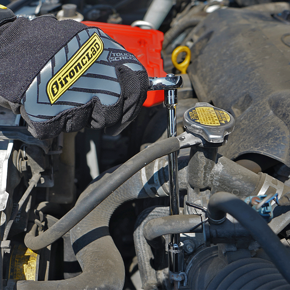 Proferred 1/4" Drive ratchet with extension bar and socket being used for automotive engine maintenance
