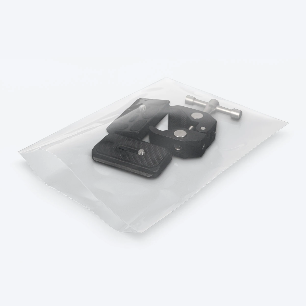 Clear open-end poly bag containing black metal hardware components.