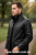 Side profile of the MLC531 black leather long coat highlighting the distinctive stand-up collar and clean silhouette. This practical design from LEATHER-SHOP.BIZ features premium craftsmanship and is custom-made in 9 colors for versatile style.