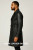 Side profile of the MLC520 black leather long coat highlighting the distinctive belted waist and tailored silhouette. This double-breasted design from LEATHER-SHOP.BIZ features premium craftsmanship and is custom-made in 9 colors for professional style.