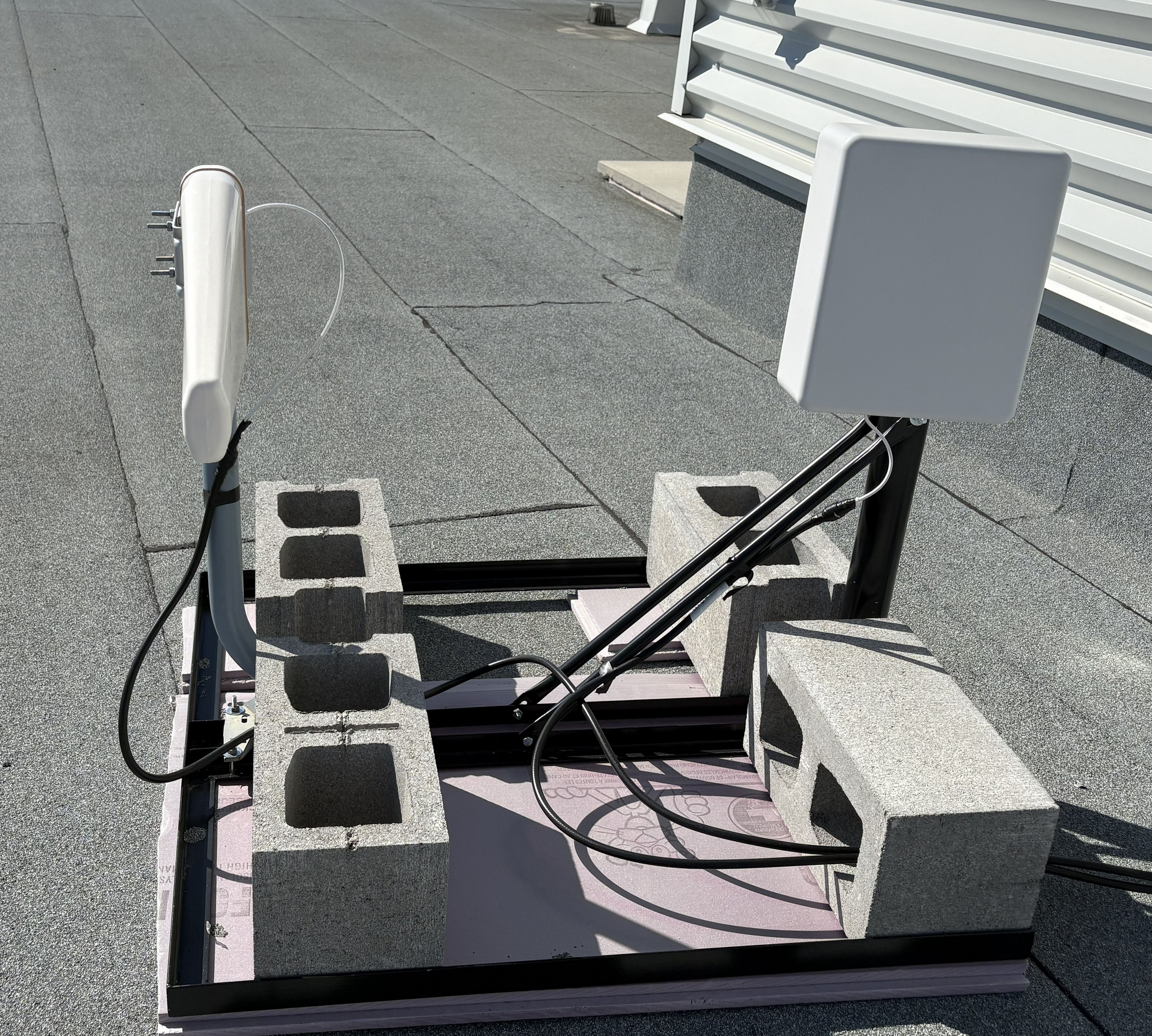 Low-band and directional mid-band donor antennas installed on the rooftop