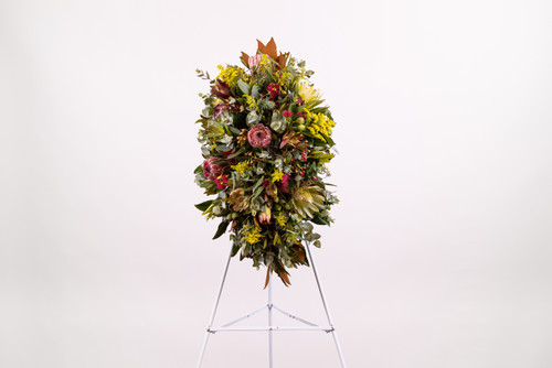 Elegant funeral standing spray featuring fresh native flowers to honour and celebrate a loved one’s life at a funeral.