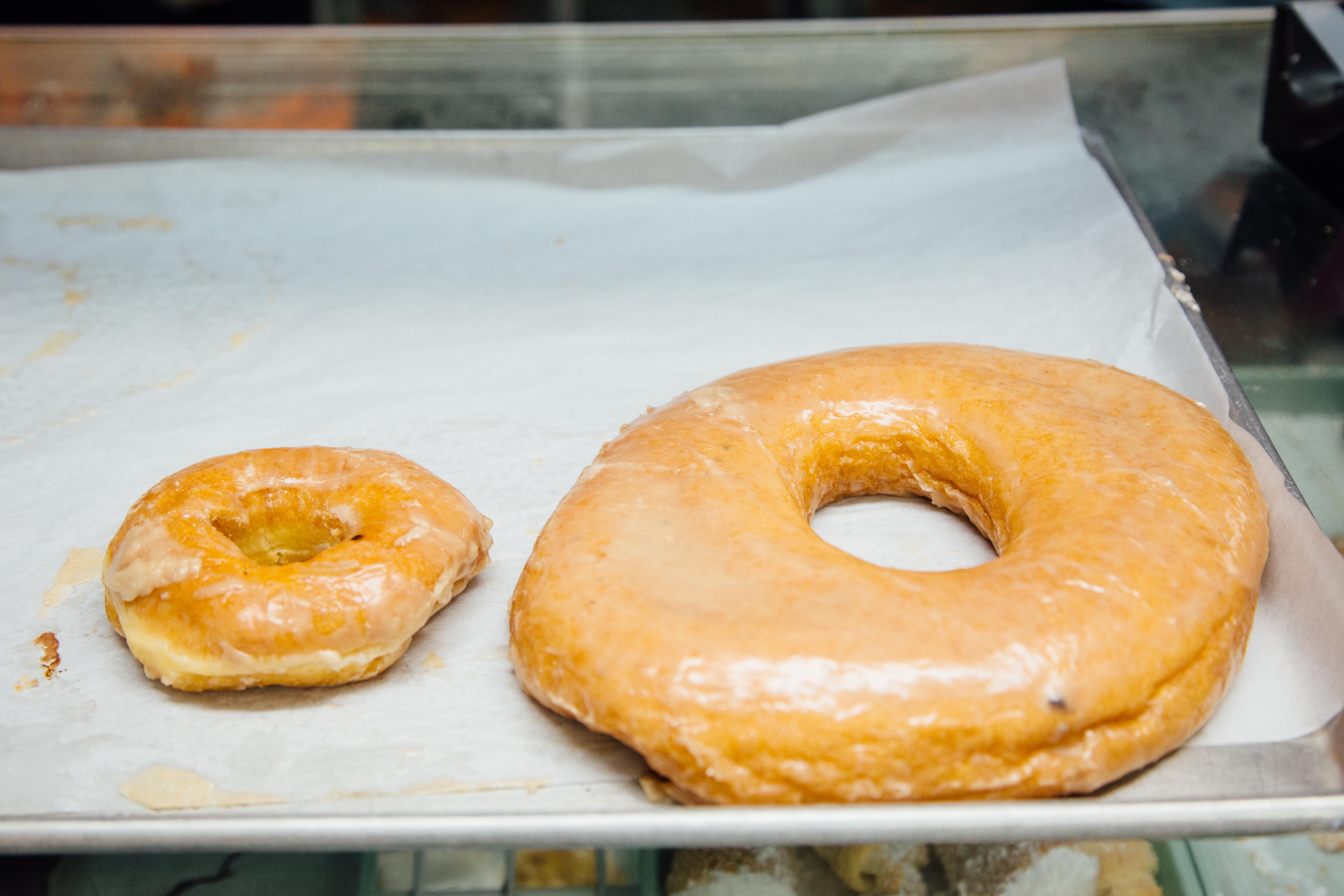 regular glazed donut next to the Texas Donut.