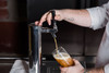 Bartender filling beer glass