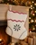 White wool Christmas stocking with embroidered snowflake decoration