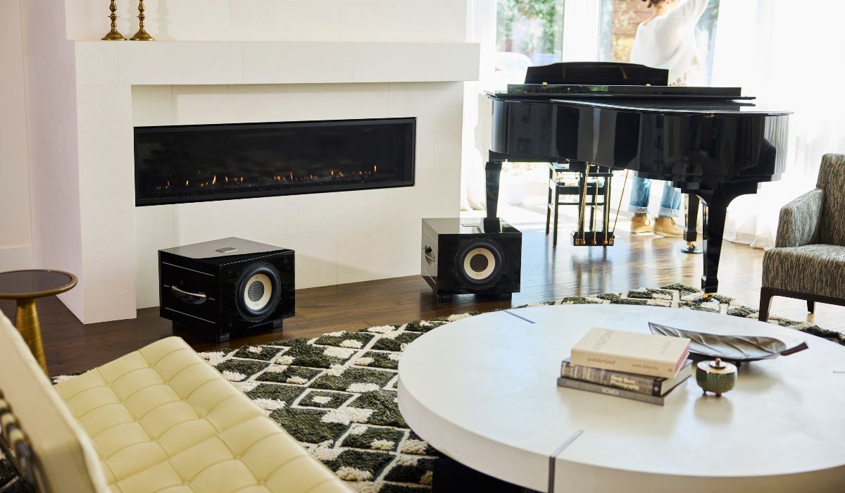 REL S550 10" Powered Subwoofer, piano black pair in elegant living room