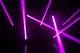 Pink light beams in a dark room