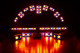 Arch of red and amber stage lights.