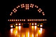 Arch of amber stage lights in the dark.