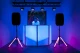 DJ setup with speakers and light stand.