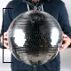 A person holding  an ADJ EM16 mirror disco ball.