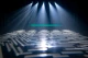 Multiple white beams projecting geometric patterns onto the floor.