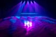 Purple and blue stage lighting projecting textured patterns across the floor.