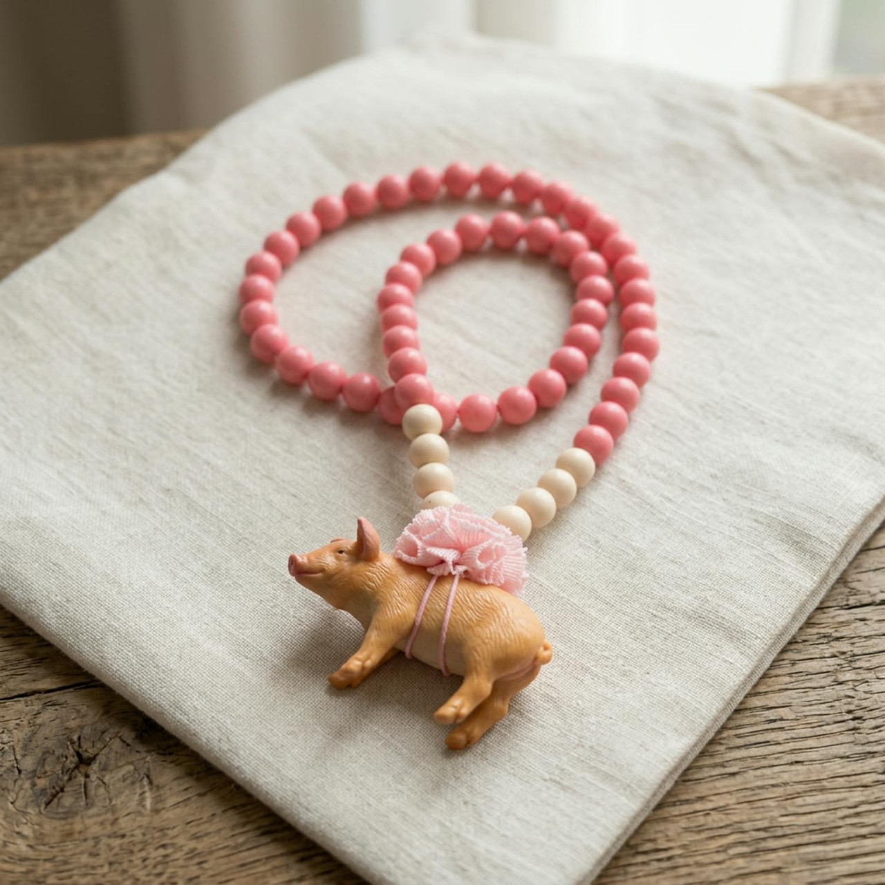 Children's pig bead necklace with pompom