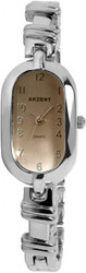 Relógio analógico feminino Akzent com movimento de quartzo, vidro mineral, caixa 20 mm (altura 10 mm) e bracelete metálica em metal. Largura da bracelete: 8 mm; comprimento: 19 cm. Fecho de correr; fundo em aço inoxidável; resistência à água 3 ATM. Marca: Akzent.