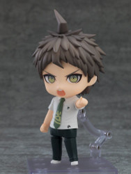 GOOD SMILE COMPANY apresenta Nendoroid de Hajime Hinata da coleção Danganronpa 1+2 Reload. Inclui três faces intercambiáveis: sorriso, expressão interrogativa e rosto em pânico. Acessórios opcionais: filme "Counter" e outras peças para diversas poses. Produto colecionável indicado para fãs.
