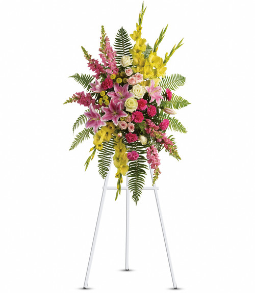 Ray of Sunshine Standing Spray by Sympathy Flower Shop. A lovely combination of flowers such as white roses, yellow gladioli and button spray chrysanthemums, pink spray roses and carnations, light pink stargazer lilies and snapdragons are arranged with a mix of beautiful greenery in a standing spray of flowers that's delivered on a funeral easel. Downtown Houston funeral flower delivery.
SKU SYM610
