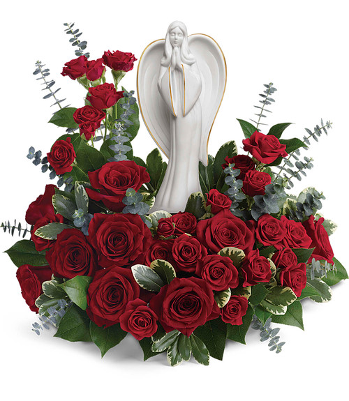 Forever Ours Funeral Angel Flowers in Red from Enchanted Florist Pasadena TX. This peaceful white porcelain angel sculpture is surrounded by radiant red roses and mini spray roses with delicate greenery, is a touching tribute to a rich life. Hand delivered with the angel statue. RM560