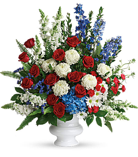 Patriotic Funeral Flowers Arrangement by Enchanted Florist Pasadena TX. A patriotic mix of all-American red, white and blue flowers such as hydrangea, roses, miniature carnations, snapdragons, mums and more are perfectly arranged in a white urn. Approximately 31" W x 34" H
SKU RM573