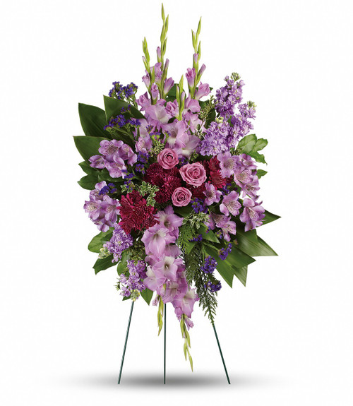 Purple Reflections Standing Spray from Sympathy Flower Shop. This royal and regal spray includes lavender roses, lavender alstroemeria, lavender gladioli, lavender stock, purple cushion spray chrysanthemums, purple sinuata statice, green ti leaves, flat cedar, oregonia and lemon leaf. Delivered on a wire funeral easel.
SKU SYM614