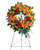 Bright and Colorful Orange Lily Funeral Wreath from Symapthy Flower Shop. Our funeral wreath features green hydrangea, hot pink spray roses, orange asiatic lilies, orange carnations, blue delphinium, purple stock, yellow cushions, sword fern, silver dollar eucalyptus, and various greenery. Delivered on a sympathy wire easel. Approximately 24" W x 34" H  
SKU SYM202