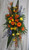 Yellow Rose Autumn Funeral Spray of Flowers from Enchanted Florist. Our autumn sympathy arrangement of flowers includes orange gerbera daisies, birds of paradise, orange spray roses, yellow spiders, blue delphinium, orange snapdragons, and are accented with various greenery and arrives on a funeral easel. Approximately 70"H x 30"W 
SKU RM515