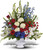 Sentimental Memories by Sympathy Flower Shop. A beautiful assortment of flowers like orange roses, gerberas and gladiolas, ti leaves, and more are beautifully arranged in an exclusive urn. Your #1 Pearland funeral florist. SKU SYM424