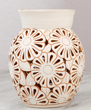 Handmade ceramic vase created by a local artist with handcrafted floral detail.