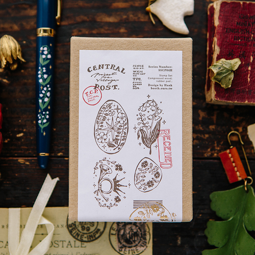 OURS Central Post A Rubber Stamp Set of 5. Vintage-style botanical postmarks, lily of the valley, and postal symbols on compressed wood blocks. Ensemble de 5 tampons en caoutchouc OURS Central Post A. Motifs de cachets de poste botaniques rétro, muguet et symboles postaux sur bois.