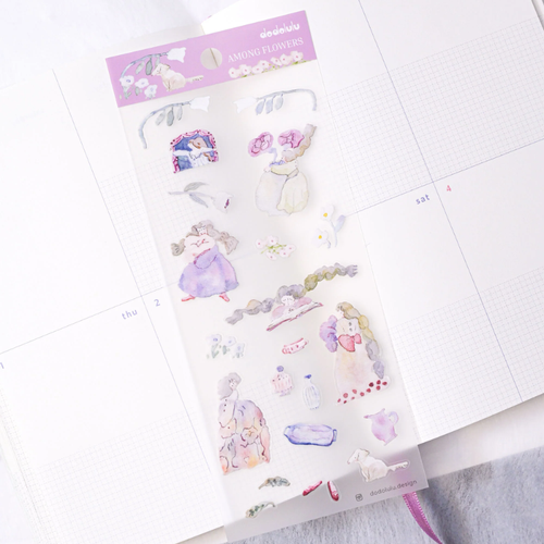 dodolulu Among Flowers Matte Sticker Sheet. A slim sticker sheet featuring hand-drawn illustrations of girls in soft outfits surrounded by large colorful flowers on matte paper. Planche de stickers mats dodolulu Among Flowers. Une planche étroite avec des illustrations de jeunes filles entourées de grandes fleurs colorées sur papier mat.